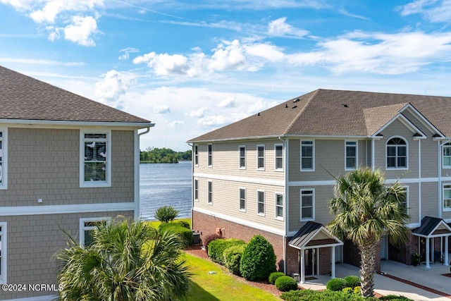 view of property exterior featuring cooling unit and a water view