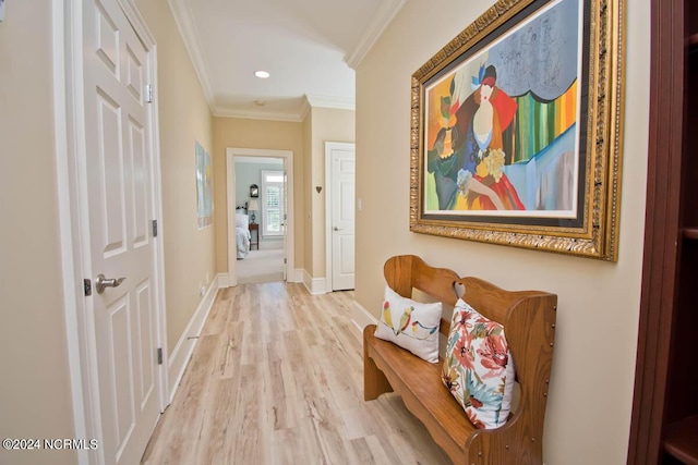 corridor with ornamental molding and light wood-type flooring