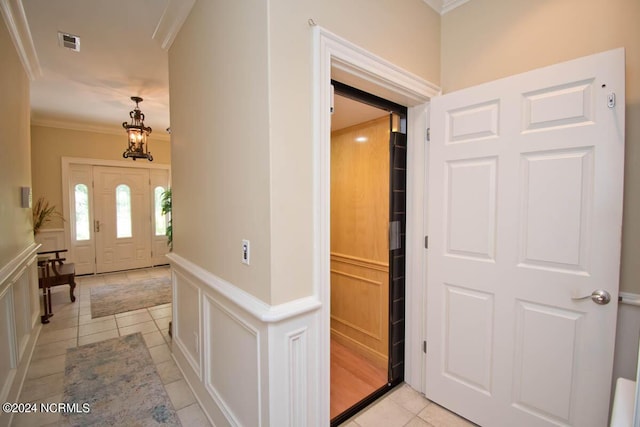 tiled entrance foyer with ornamental molding