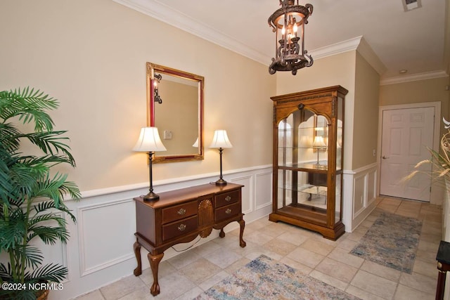 interior space featuring ornamental molding and a notable chandelier