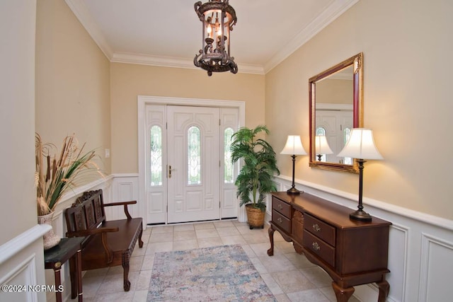 foyer entrance with a notable chandelier, crown molding, and light tile patterned flooring