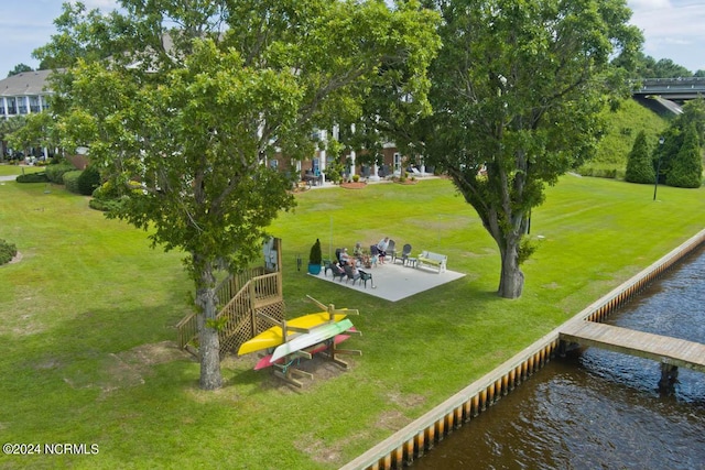 view of home's community with a water view, a yard, and a patio area