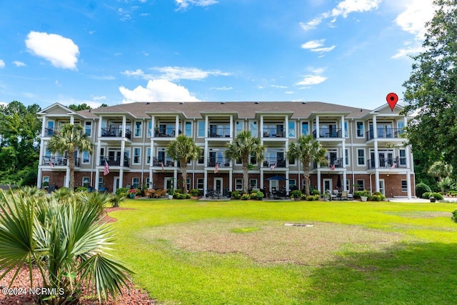 view of property's community with a lawn