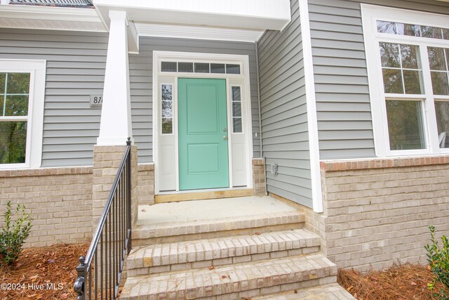 entrance to property with brick siding