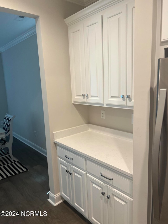 kitchen with crown molding, white cabinets, and dark wood-type flooring