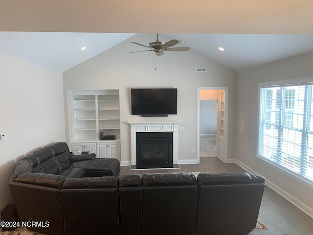 living room with a healthy amount of sunlight, vaulted ceiling, hardwood / wood-style floors, and ceiling fan