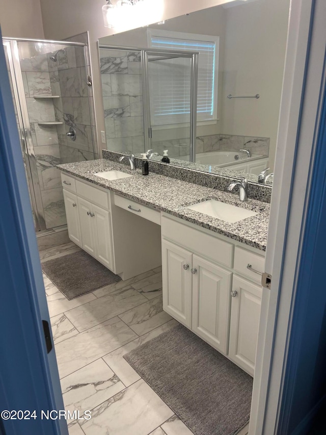 bathroom with tile floors, shower with separate bathtub, and double sink vanity