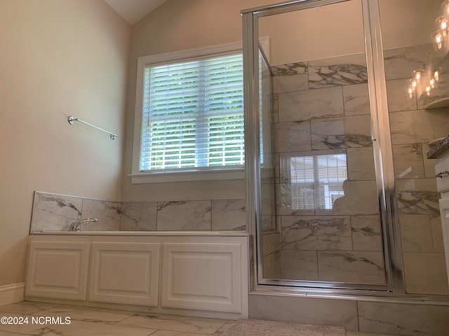 bathroom with tile floors, walk in shower, and vaulted ceiling