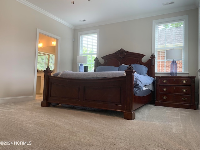 bedroom with crown molding and light colored carpet