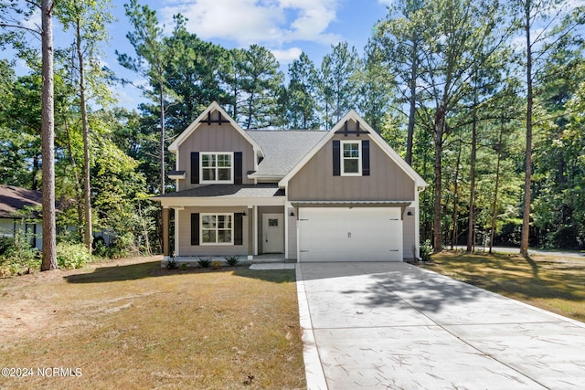 view of front of home featuring a front yard and a garage