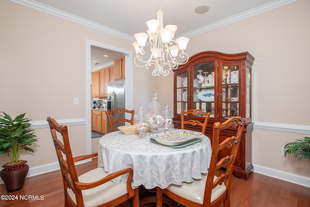 dining space with dark hardwood / wood-style floors, a notable chandelier, and crown molding