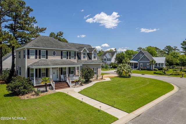 colonial inspired home featuring a front lawn and a porch