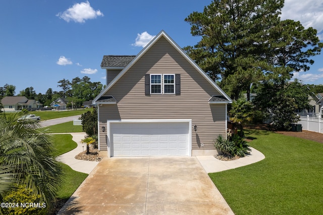 view of side of home featuring a garage and a lawn