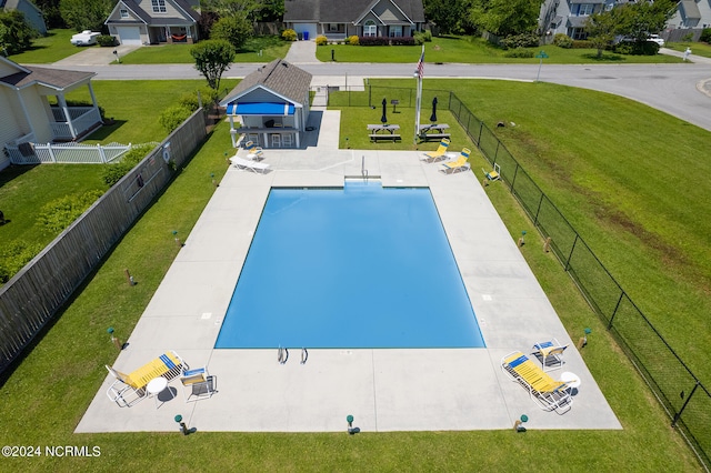 view of swimming pool with a yard and a patio