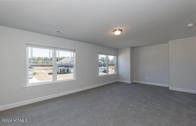 empty room featuring dark colored carpet