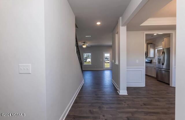 hallway featuring dark wood-type flooring