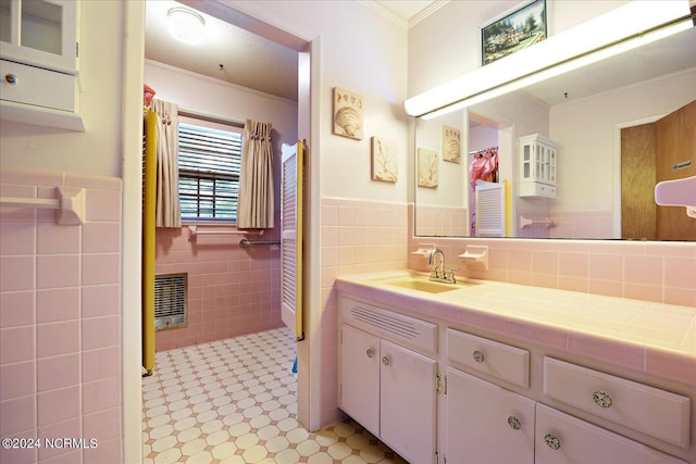 bathroom featuring vanity, tile walls, and ornamental molding