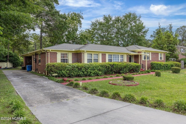 ranch-style home featuring a front yard