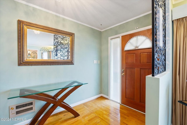 entrance foyer featuring wood-type flooring and crown molding