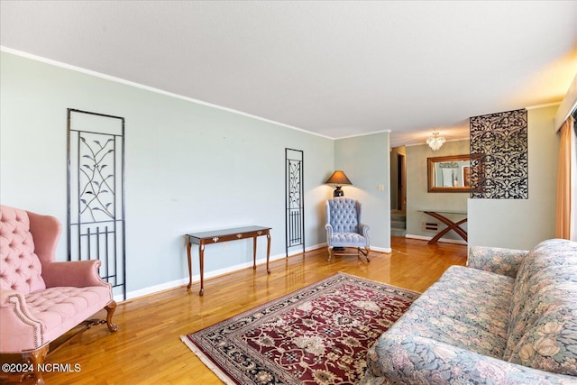 living room with hardwood / wood-style floors and crown molding