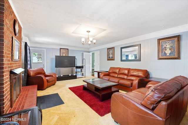 living room featuring a fireplace, ornamental molding, a textured ceiling, a chandelier, and carpet floors