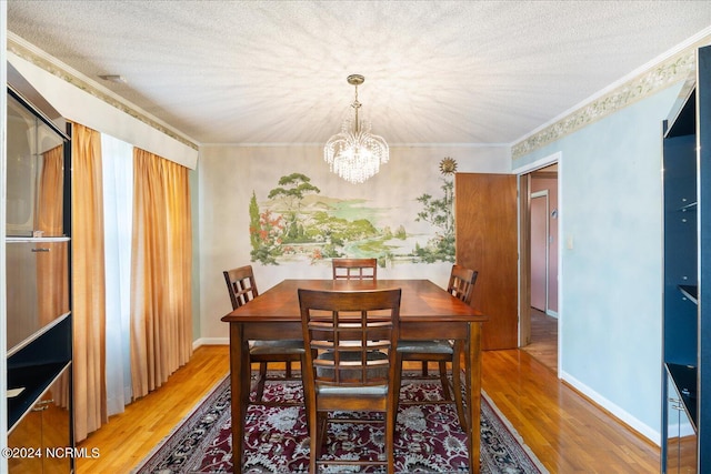 dining space with crown molding, a textured ceiling, and hardwood / wood-style flooring