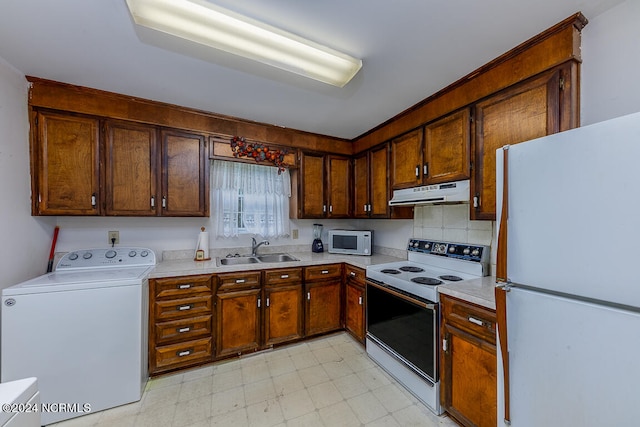 kitchen with white appliances, tasteful backsplash, washer / clothes dryer, sink, and light tile floors