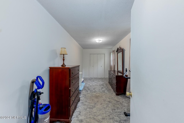 hall with carpet and a textured ceiling