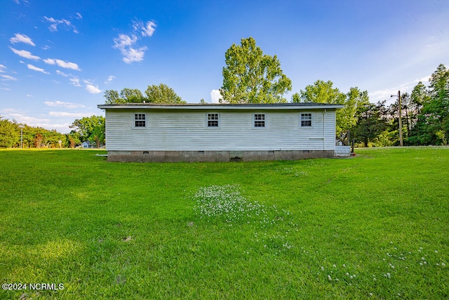 rear view of property with a yard