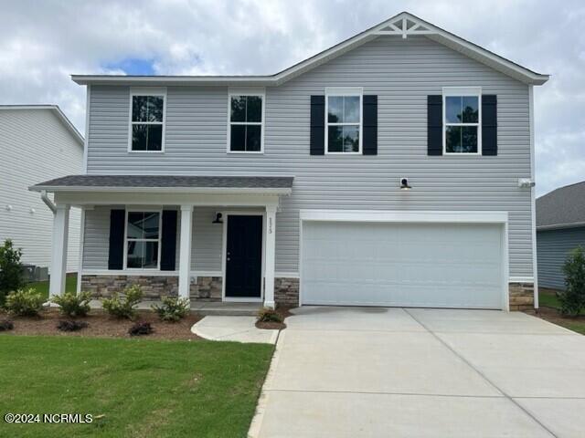 view of front facade featuring a front lawn, a garage, and a porch