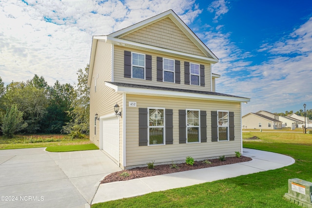 view of front of home featuring a front yard and a garage