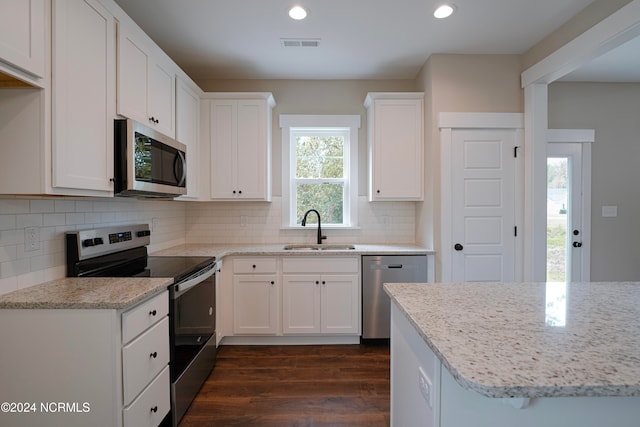 kitchen with sink, white cabinetry, stainless steel appliances, and dark hardwood / wood-style flooring