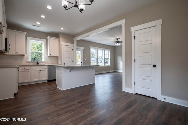 kitchen featuring white cabinets, a wealth of natural light, and a kitchen island