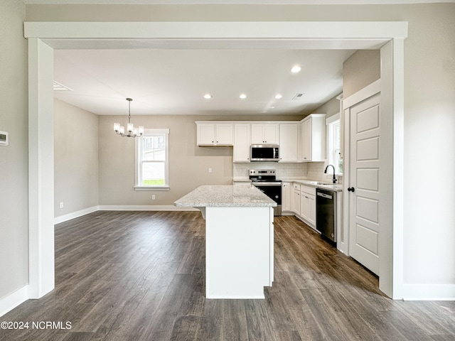 kitchen with sink, a center island, dark hardwood / wood-style flooring, white cabinetry, and stainless steel appliances