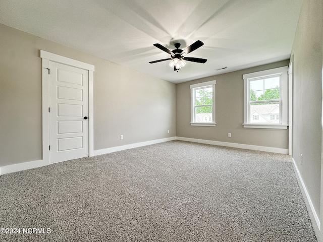 carpeted empty room with ceiling fan