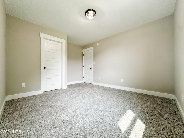 unfurnished bedroom featuring carpet and a closet