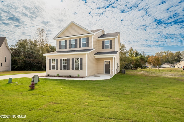 view of front of house with central air condition unit, a patio area, and a front lawn