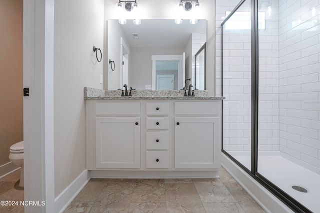 bathroom featuring vanity, toilet, and an enclosed shower