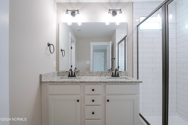 bathroom with vanity and an enclosed shower