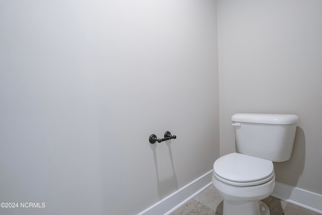 bathroom with toilet and tile patterned floors