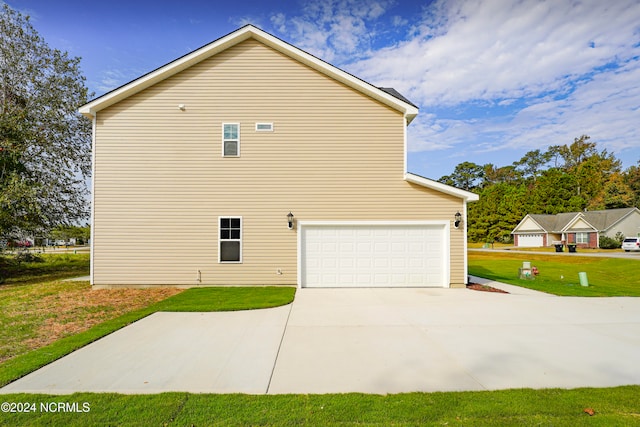 view of property exterior with a yard and a garage