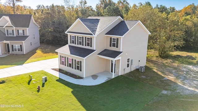 view of front facade featuring a front lawn and central AC unit