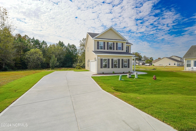 view of front of house featuring a front lawn and a garage