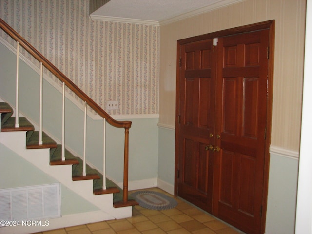 tiled foyer with crown molding