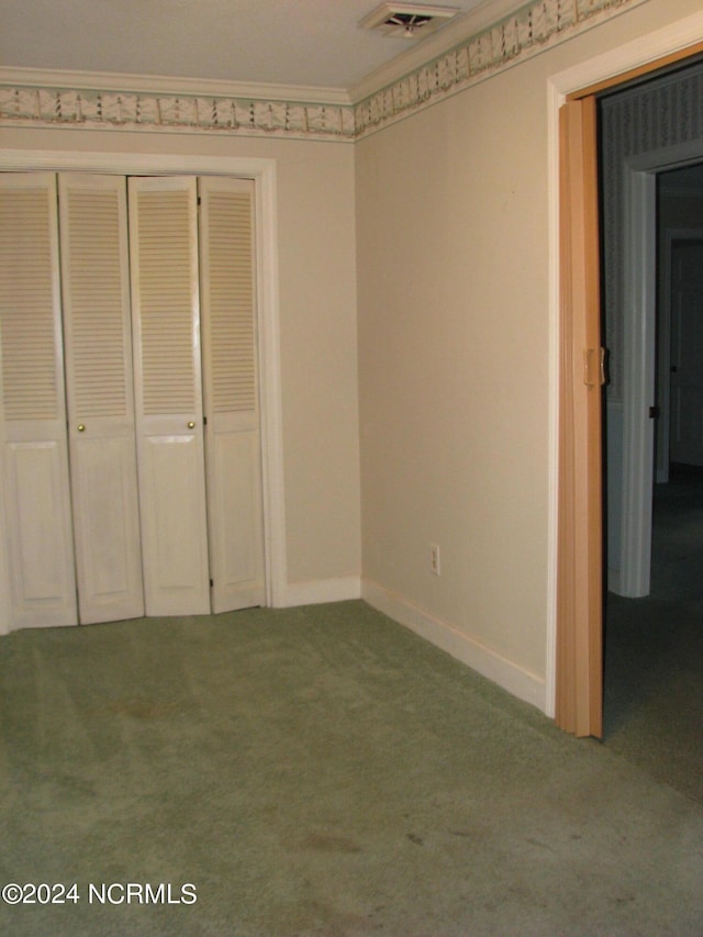 unfurnished bedroom with carpet flooring and a closet