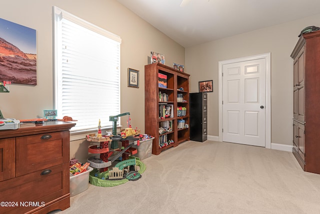 recreation room featuring light carpet and a wealth of natural light