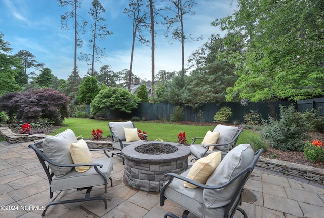 view of terrace with an outdoor fire pit