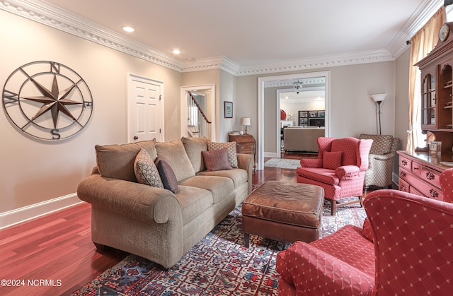 living room featuring ornamental molding and dark hardwood / wood-style floors