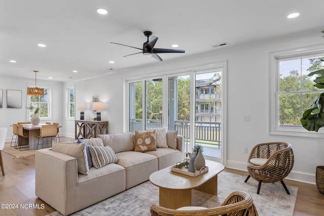 living room with plenty of natural light and light hardwood / wood-style flooring