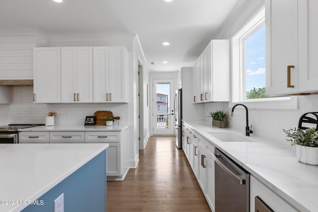 kitchen with sink, white cabinetry, stainless steel appliances, and a wealth of natural light